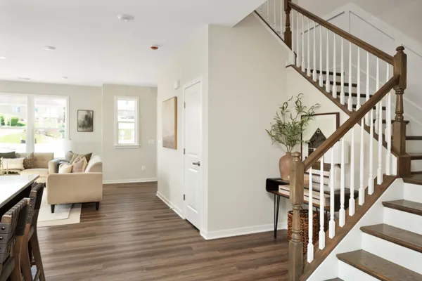 a living room with wooden floor and stairs