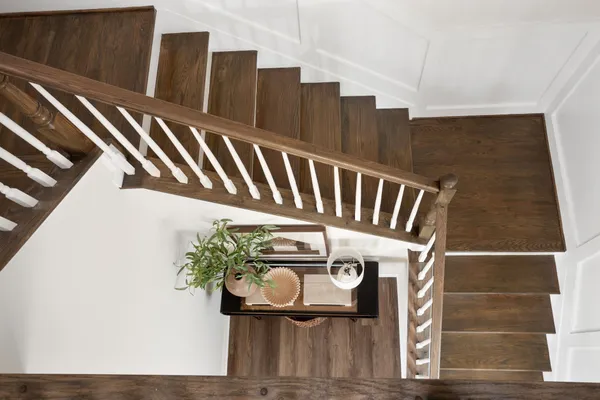 a view of staircase with railing and white walls