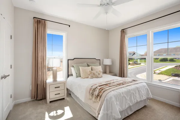 a bedroom with a large bed and a window