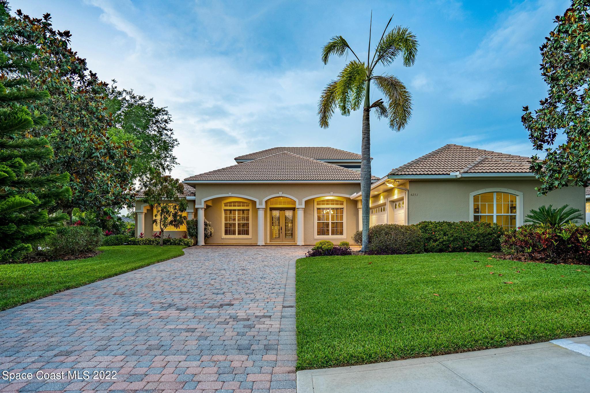 4251 Stoney Point Road Melbourne, FL 32940 - Photo 1 of 62 a front view of a house with a yard and garage