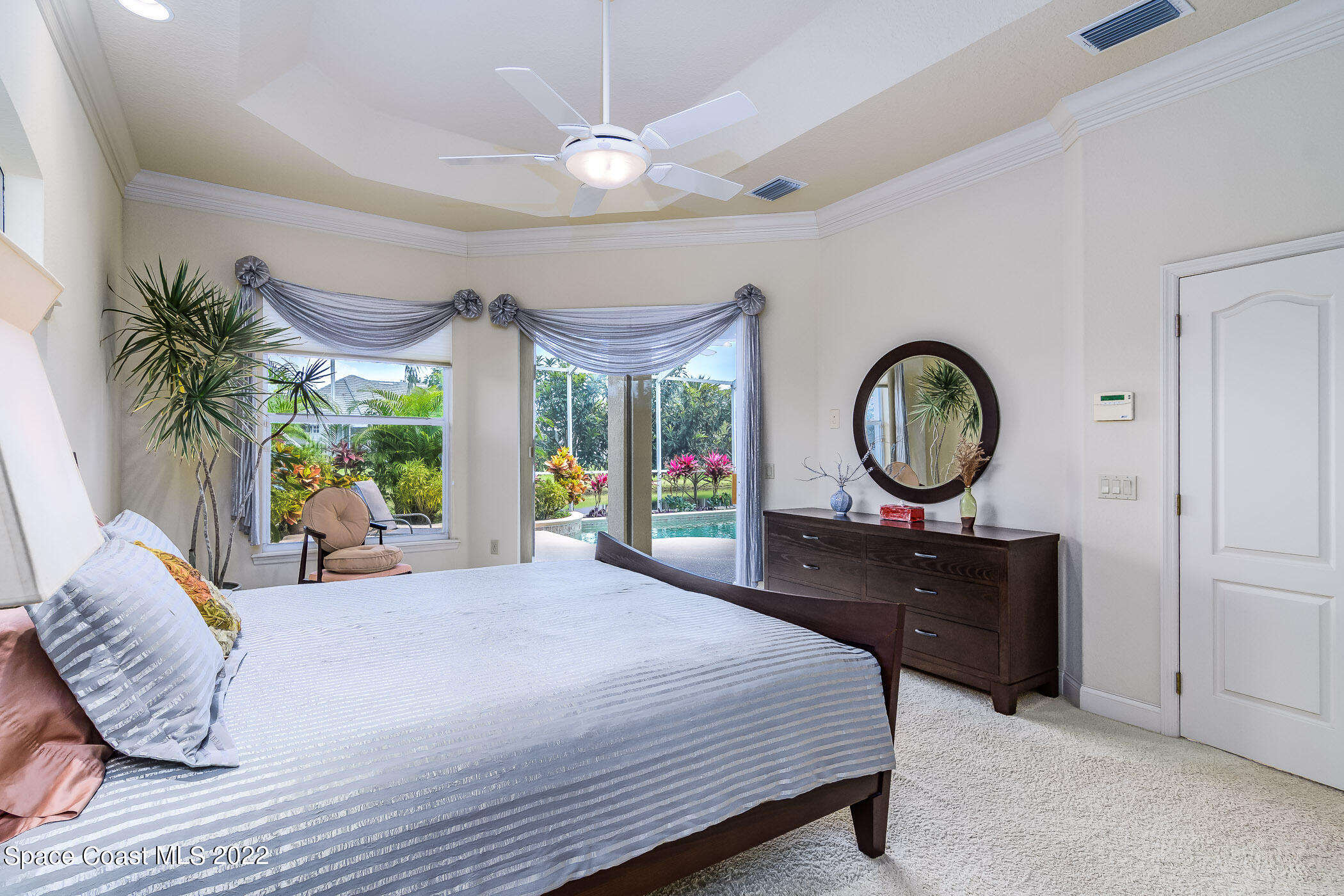 4251 Stoney Point Road Melbourne, FL 32940 - Photo 19 of 62 a bedroom with a large bed and a large window