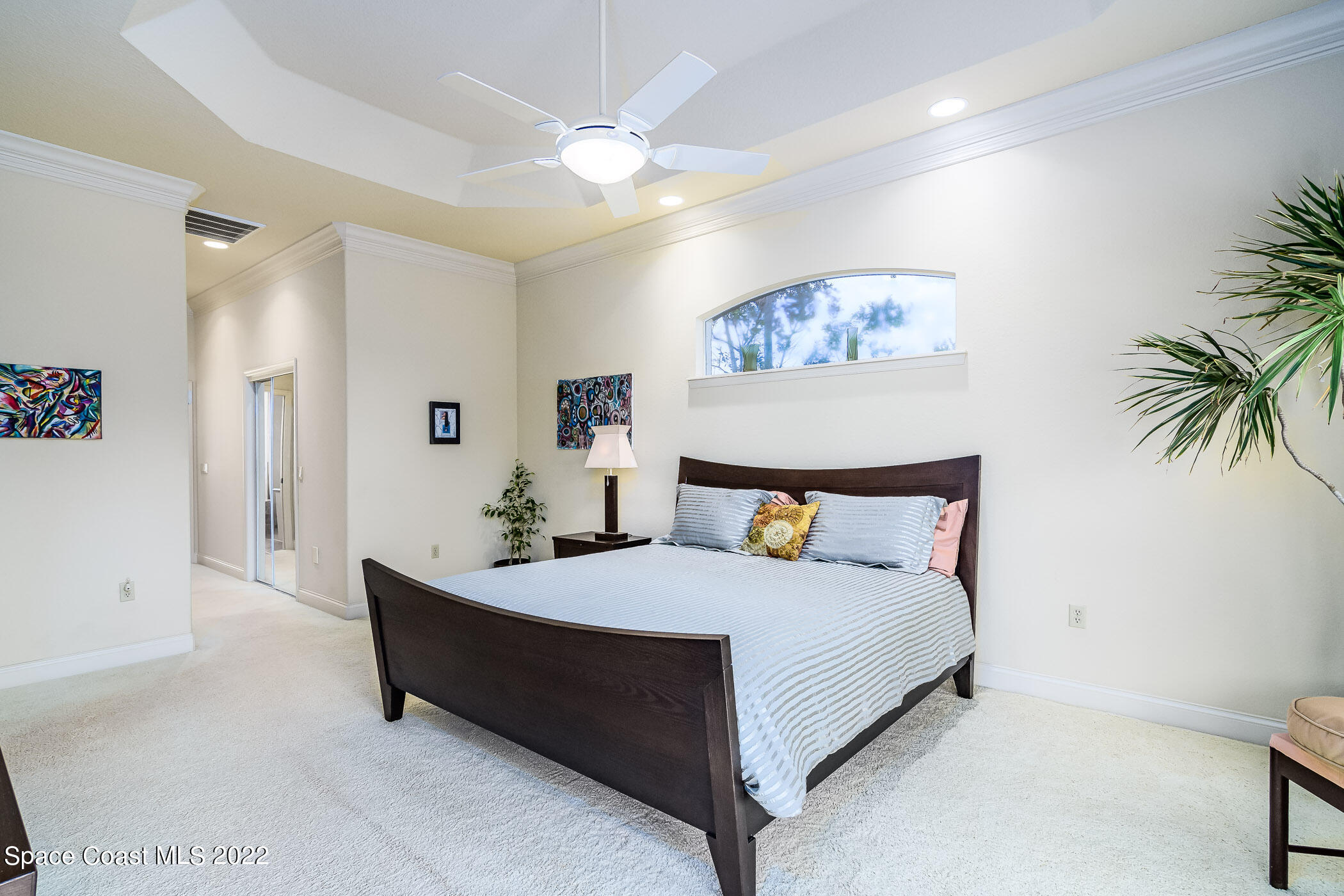 4251 Stoney Point Road Melbourne, FL 32940 - Photo 20 of 62 a spacious bedroom with a bed and a couch