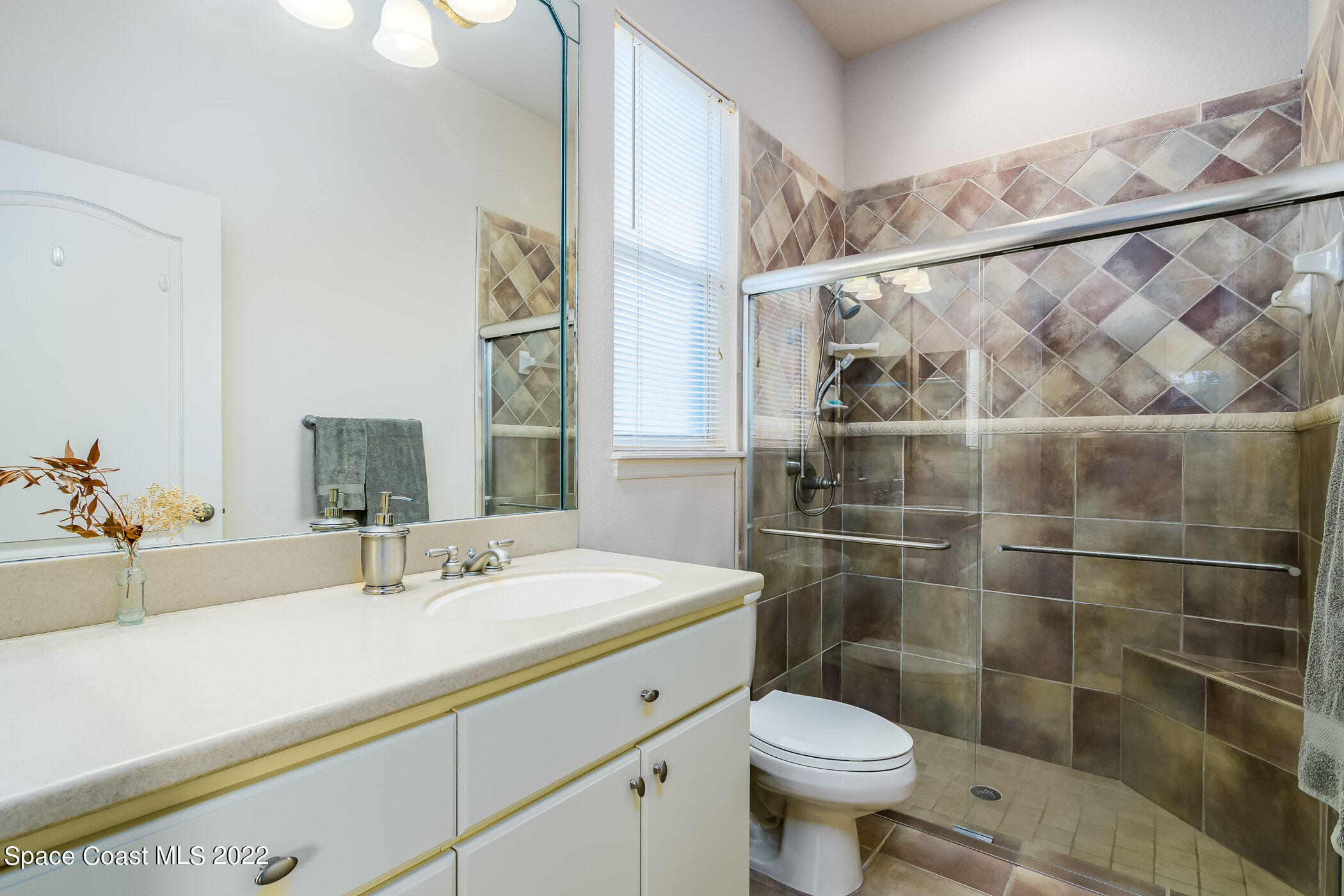 4251 Stoney Point Road Melbourne, FL 32940 - Photo 25 of 62 a bathroom with a sink toilet and a mirror