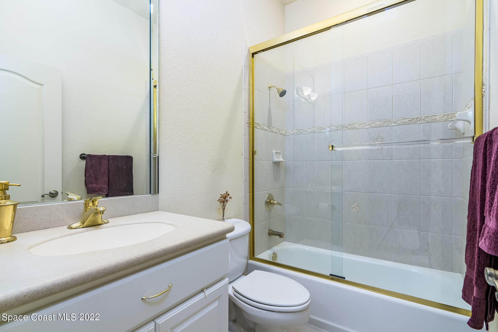 4251 Stoney Point Road Melbourne, FL 32940 - Photo 27 of 62 a bathroom with a bathtub shower sink vanity and toilet