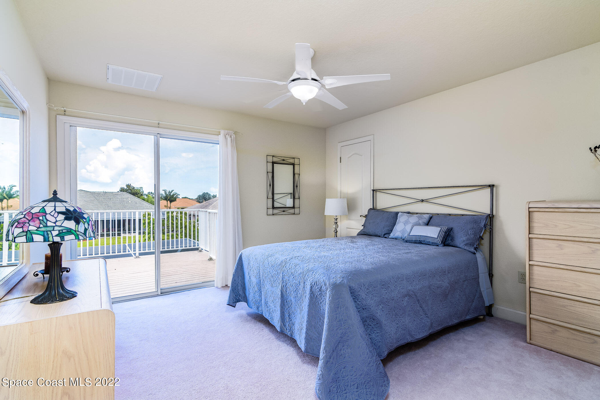 4251 Stoney Point Road Melbourne, FL 32940 - Photo 29 of 62 a bedroom with a balcony a bed and a chandelier