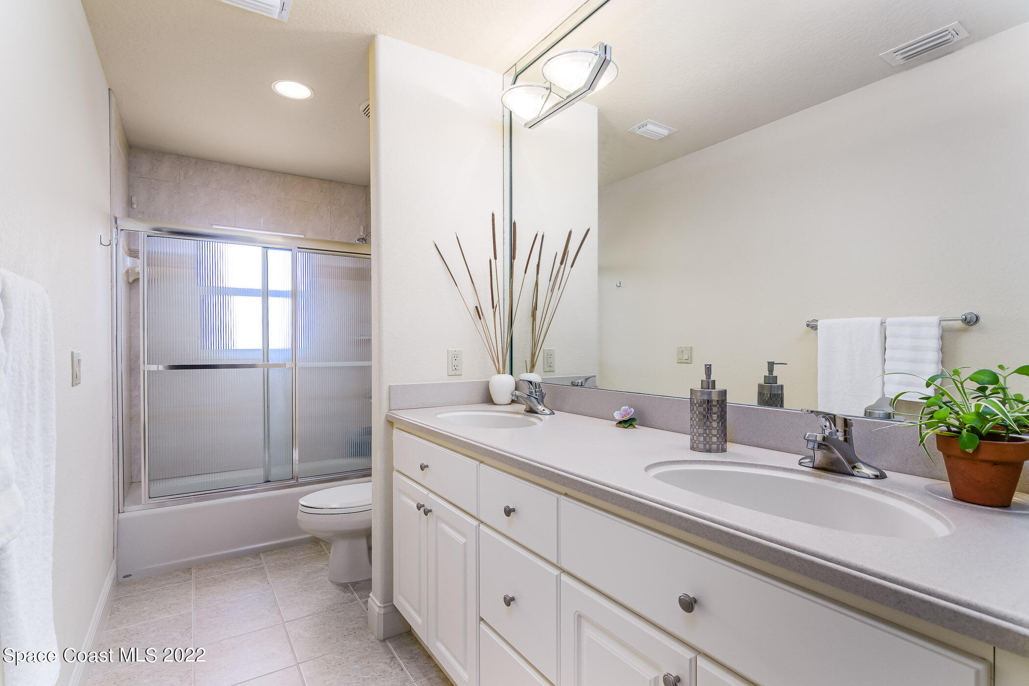 4251 Stoney Point Road Melbourne, FL 32940 - Photo 30 of 62 a bathroom with a sink a toilet and shower