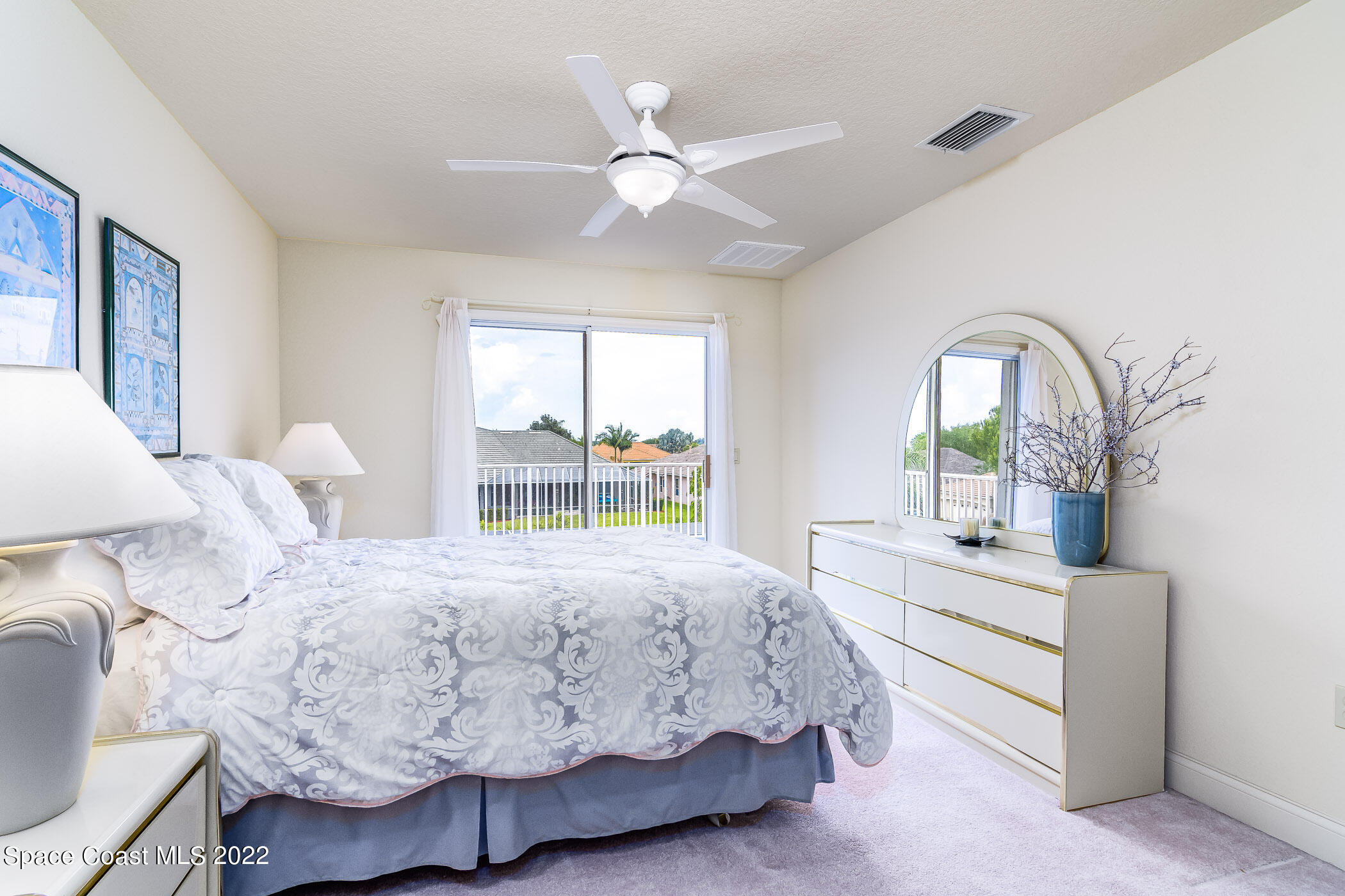 4251 Stoney Point Road Melbourne, FL 32940 - Photo 31 of 62 a bedroom with a bed a window and potted plant on the dresser
