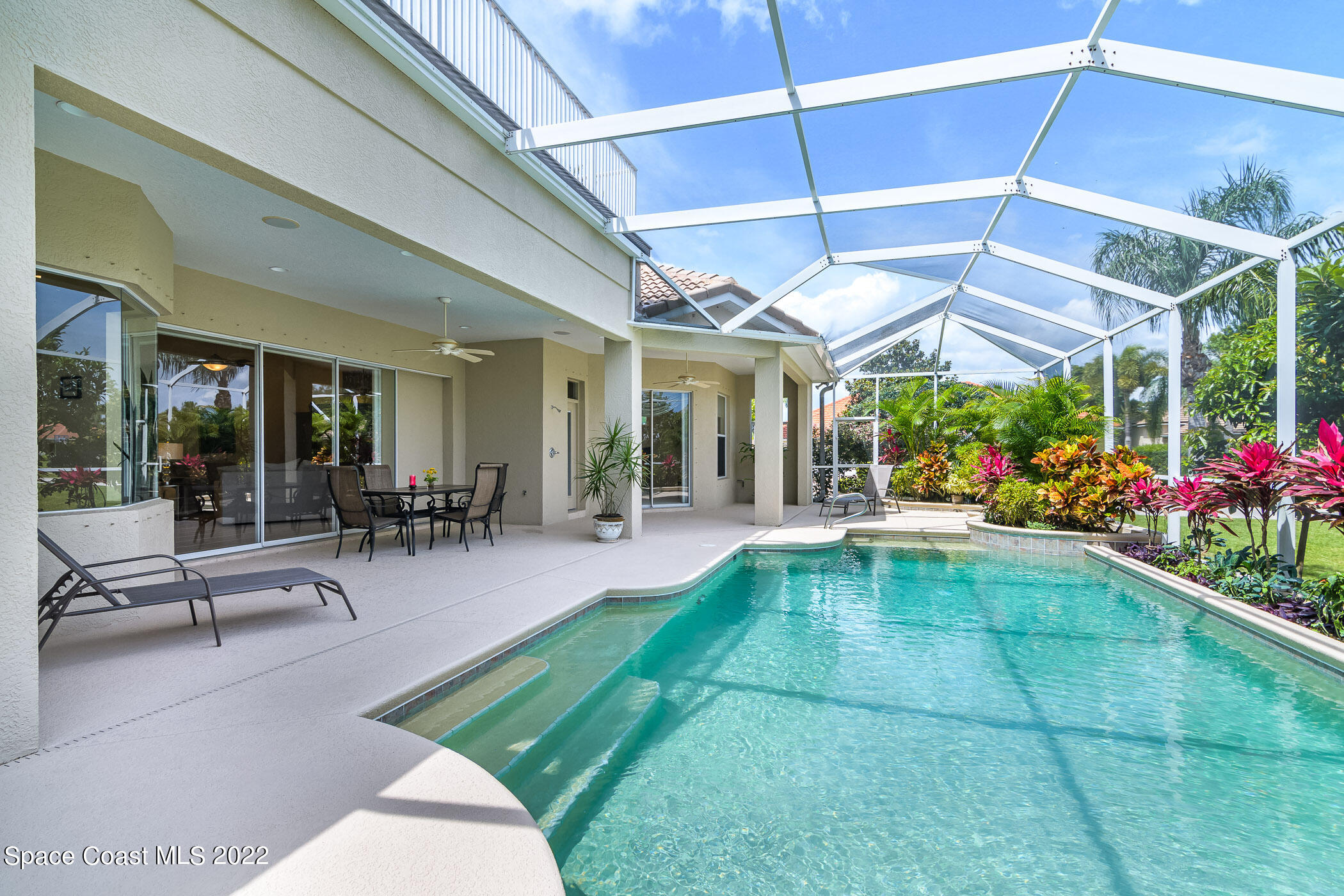 4251 Stoney Point Road Melbourne, FL 32940 - Photo 42 of 62 a view of a patio with a table and chairs under an umbrella