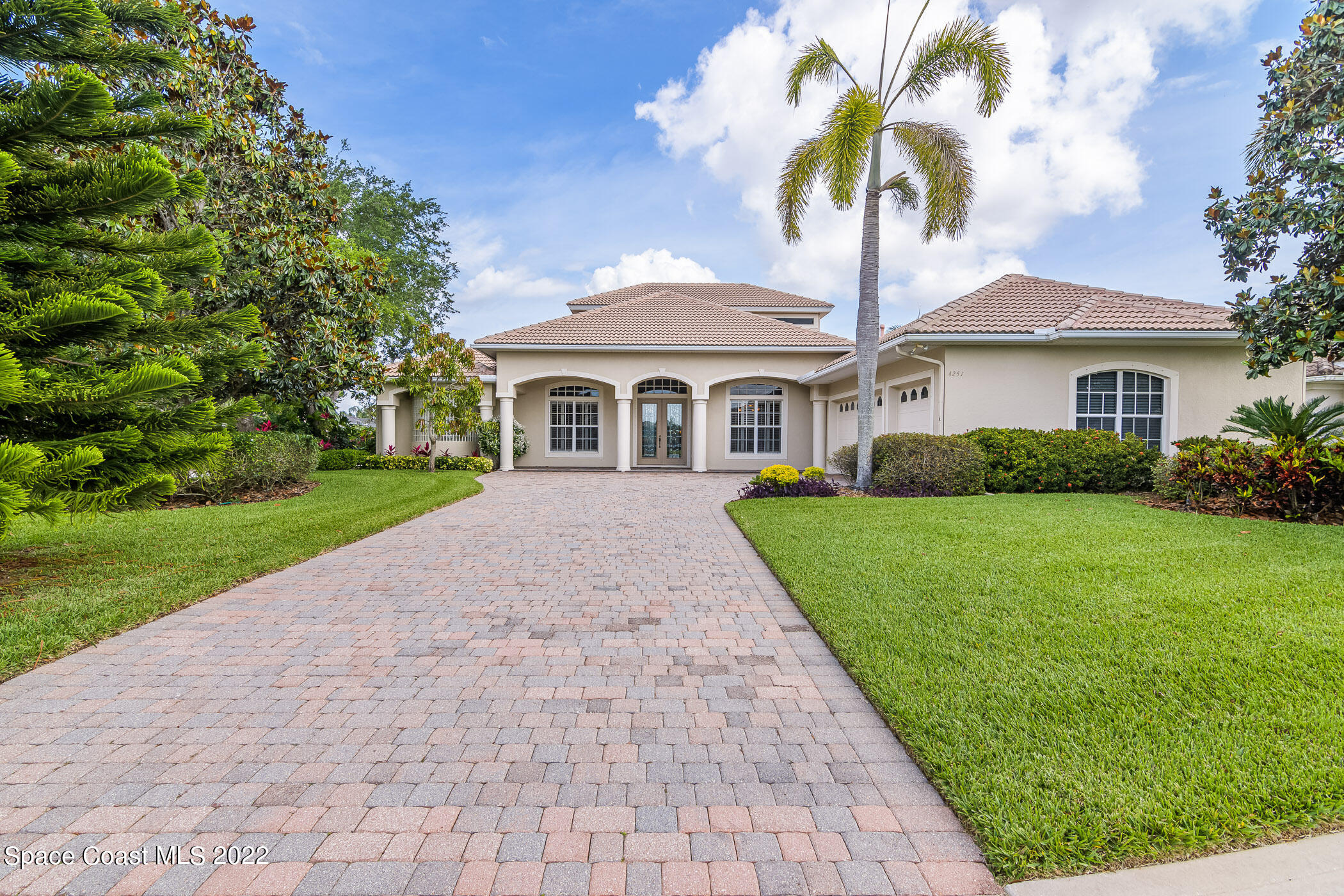4251 Stoney Point Road Melbourne, FL 32940 - Photo 53 of 62 a front view of a house with a yard and potted plants