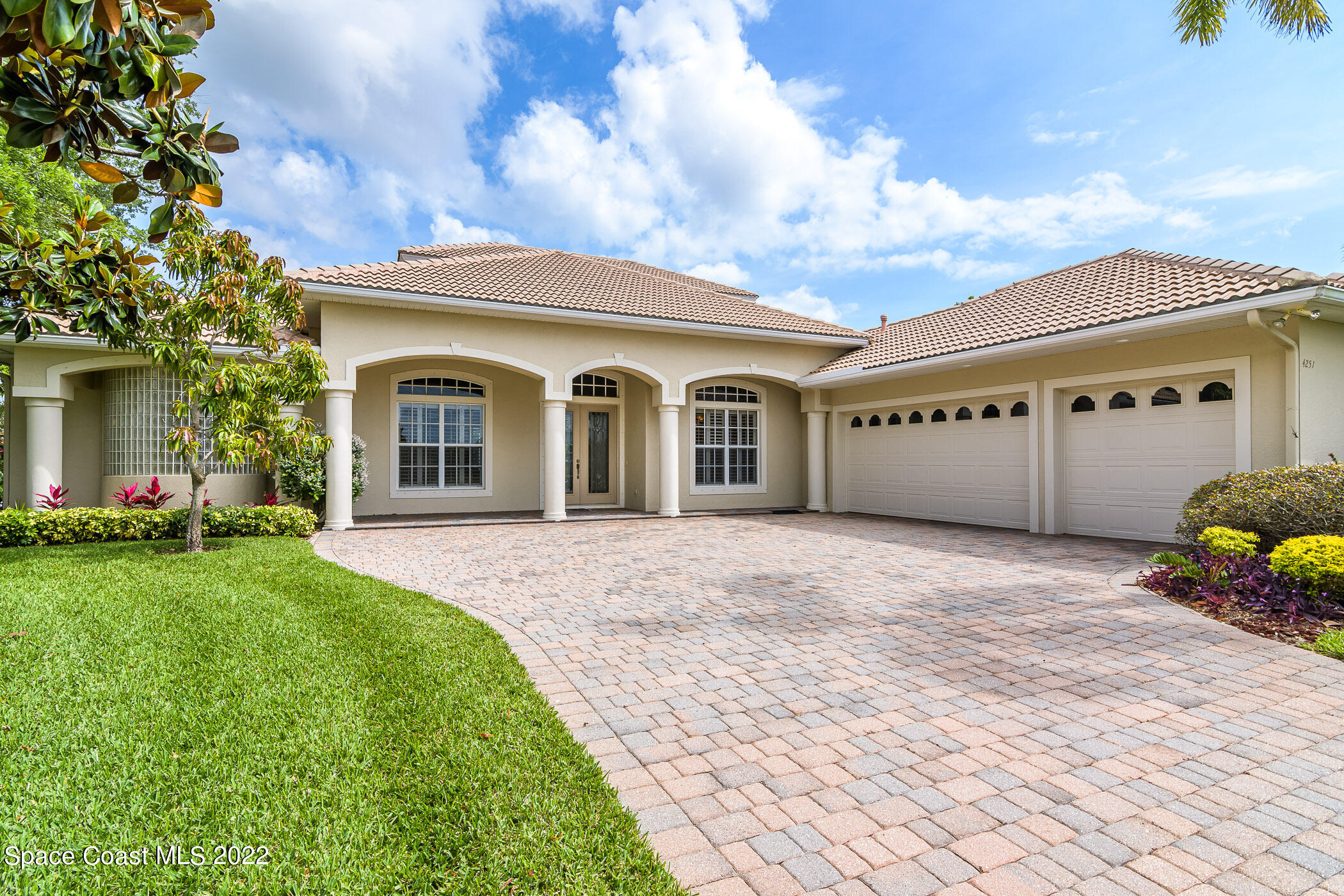 4251 Stoney Point Road Melbourne, FL 32940 - Photo 54 of 62 a view of a white house with a big yard and large tree