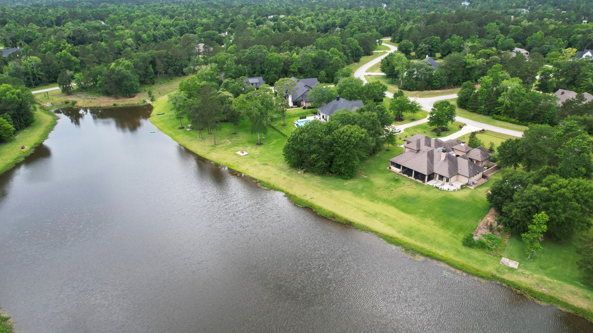 6918 Comanche Bend Montgomery, TX 77316 - Photo 2 of 50 The lake behind 6918 Comanche Bend is private to the homeowners that border the lake, stocked with a variety of fish, such as Big Mouth Bass!