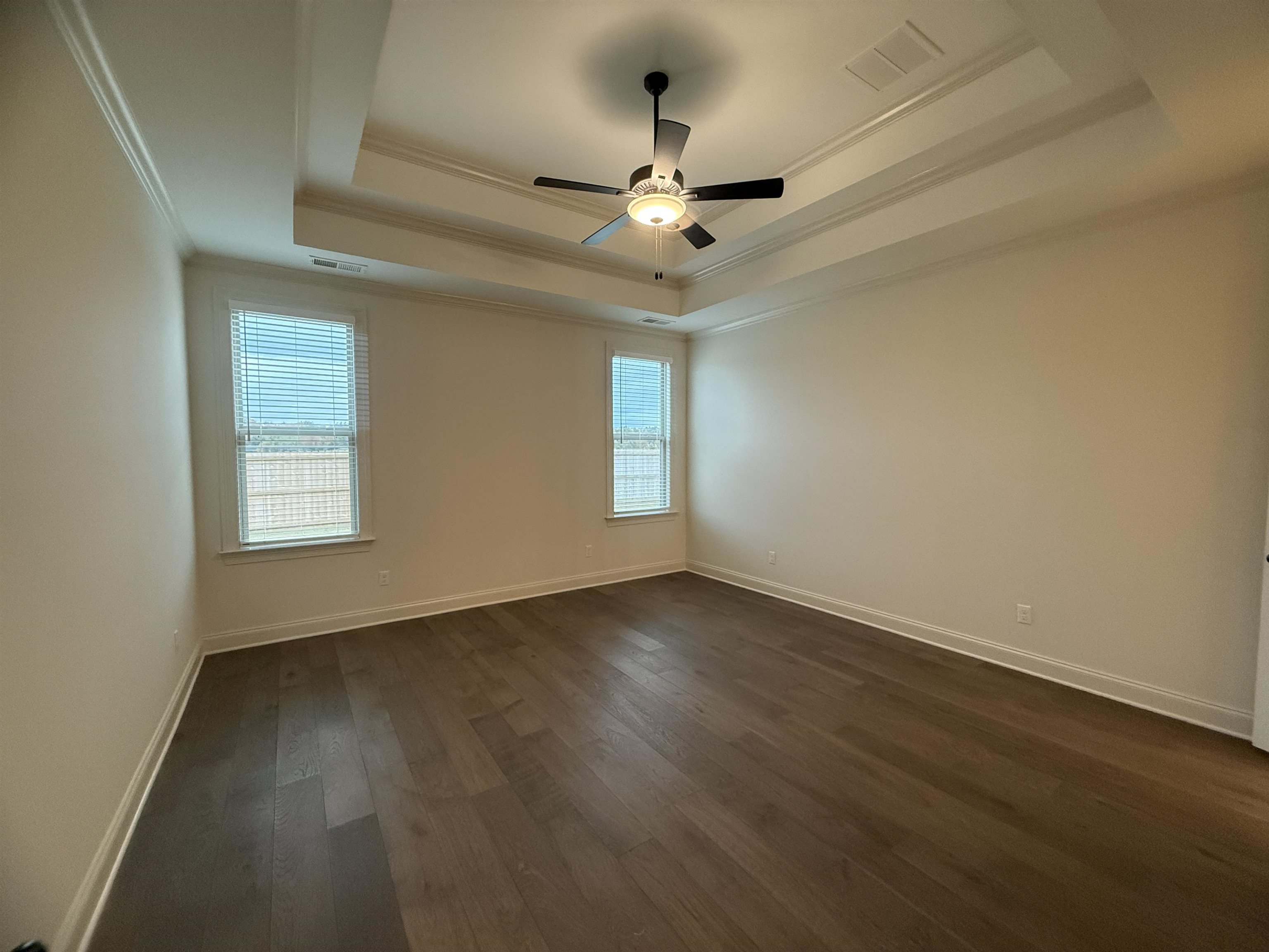 11504 Sunsparkler Way Collierville, TN 38017 - Photo 12 of 13 an empty room with wooden floor ceiling fan and windows