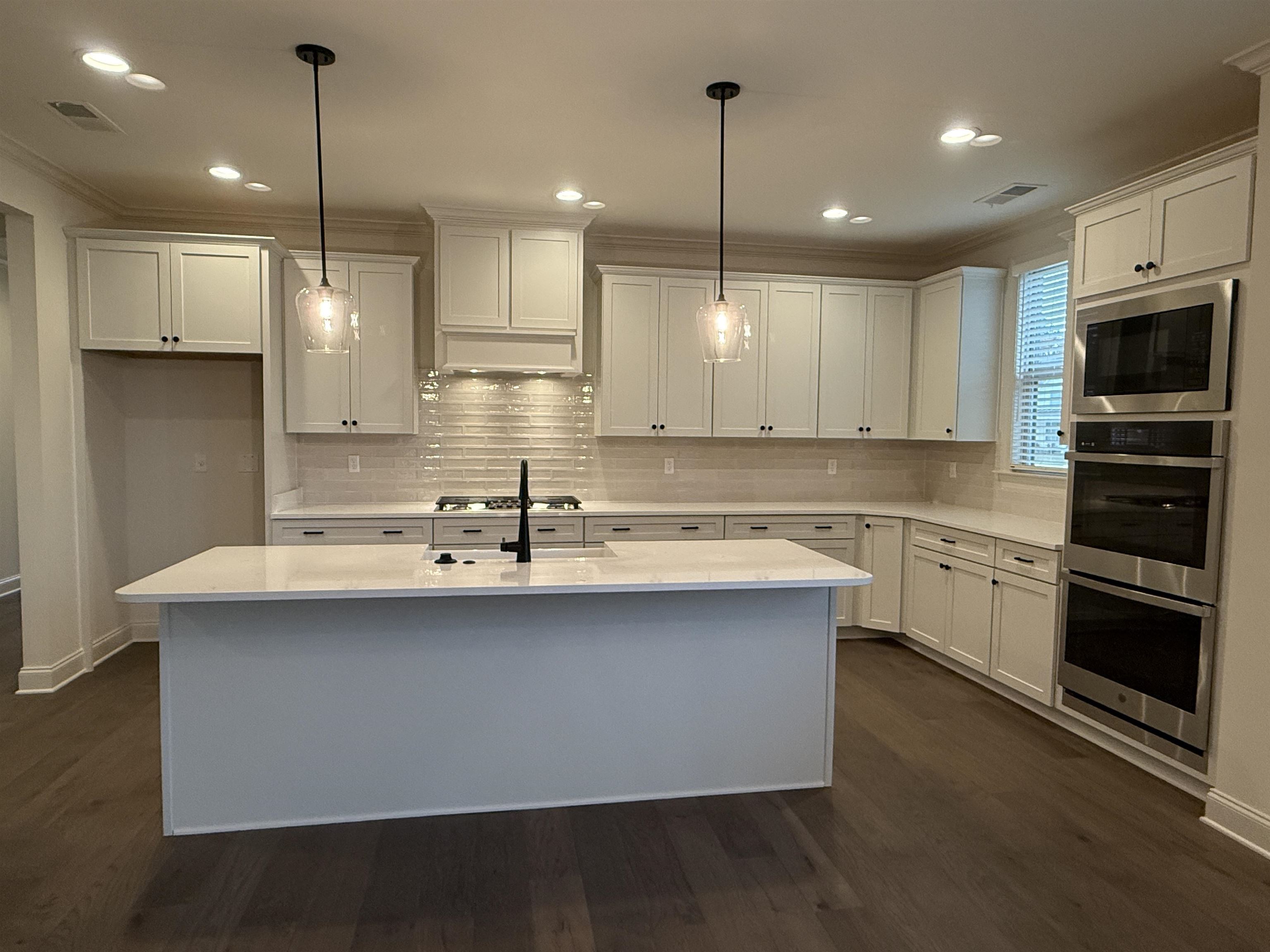 11504 Sunsparkler Way Collierville, TN 38017 - Photo 2 of 13 a kitchen with kitchen island a sink stainless steel appliances and cabinets