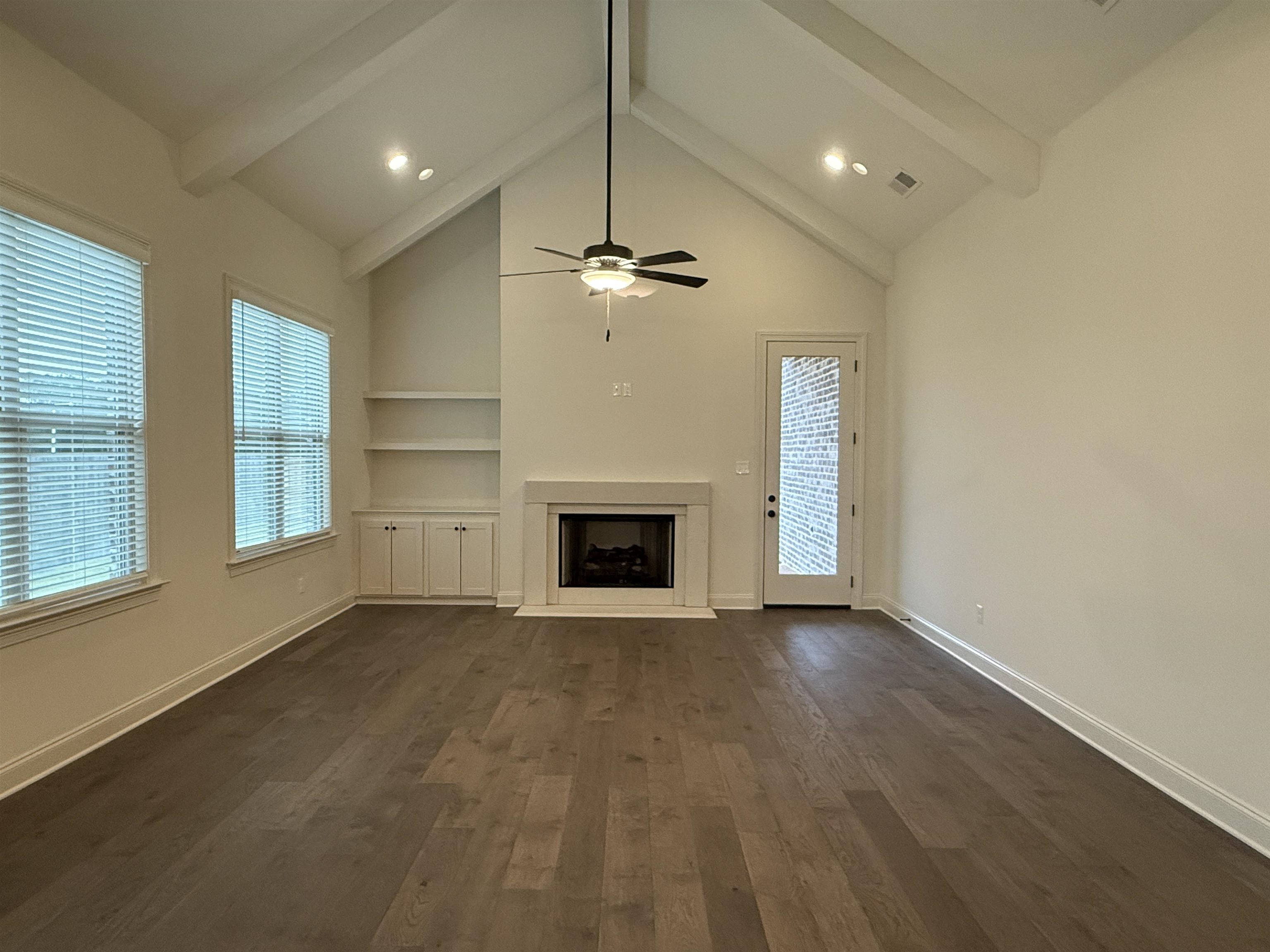 11504 Sunsparkler Way Collierville, TN 38017 - Photo 3 of 13 an empty room with windows and fireplace