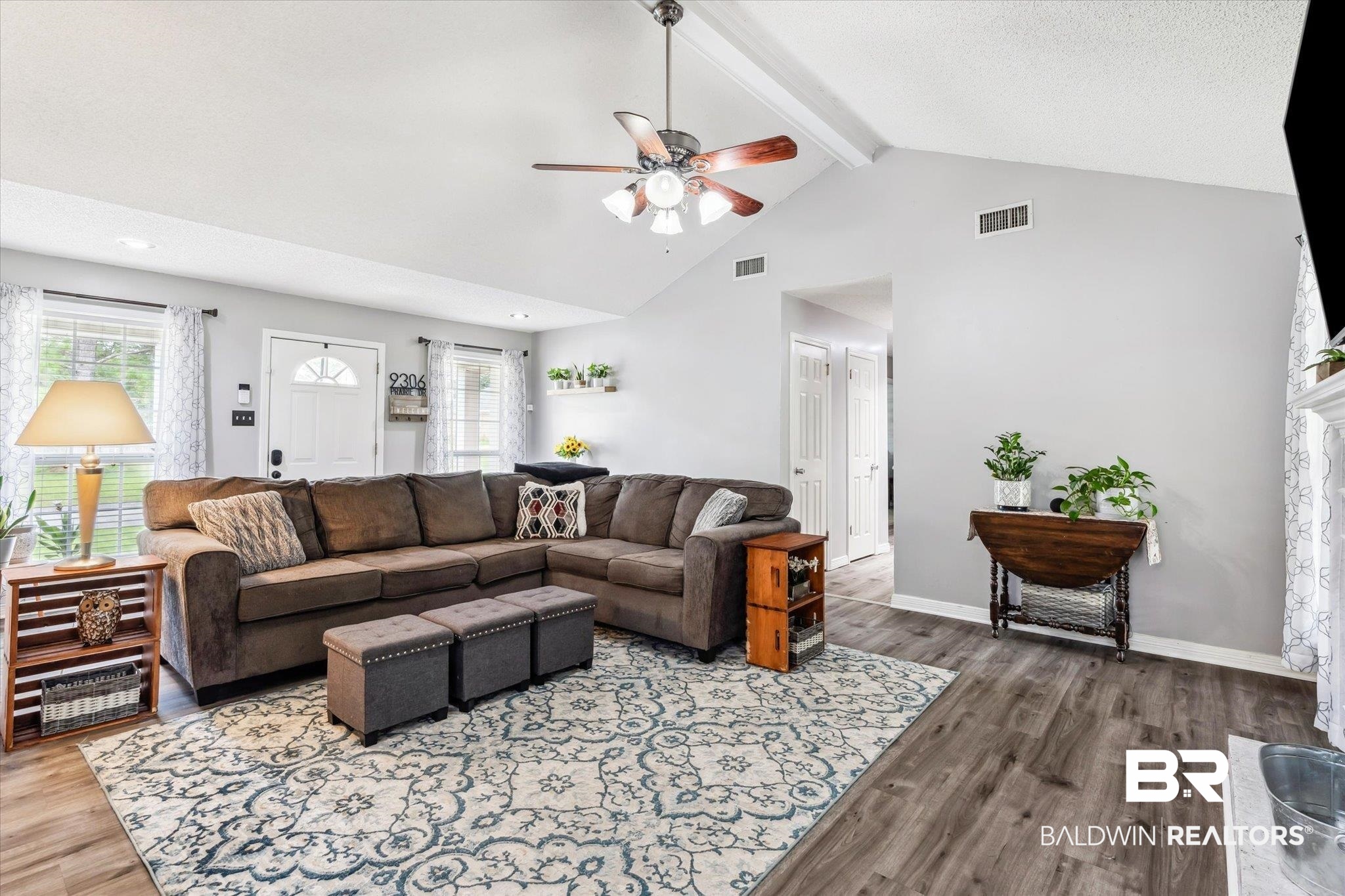 9306 Prairie Drive Semmes, AL 36575 - Photo 2 of 20 Living room featuring beam ceiling, hardwood / wood-style flooring, high vaulted ceiling, and ceiling fan