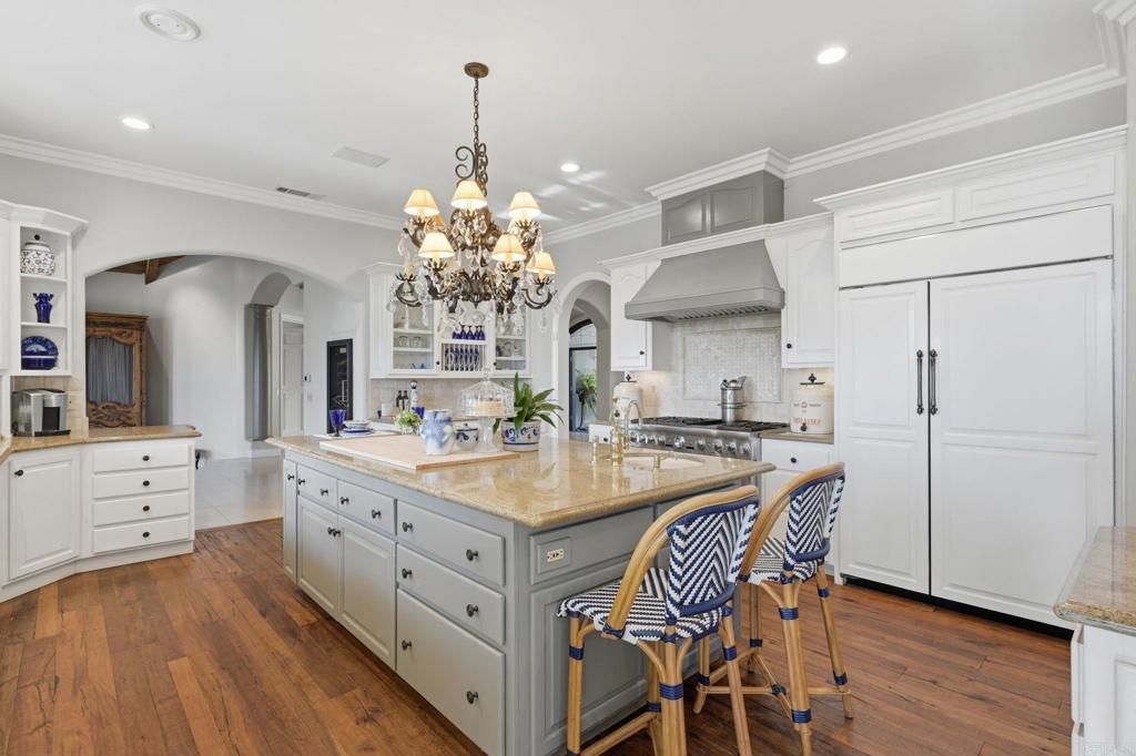 4248 Citrus Drive Fallbrook, CA 92028 - Photo 14 of 71 a kitchen with stainless steel appliances a dining table chairs and wooden floor