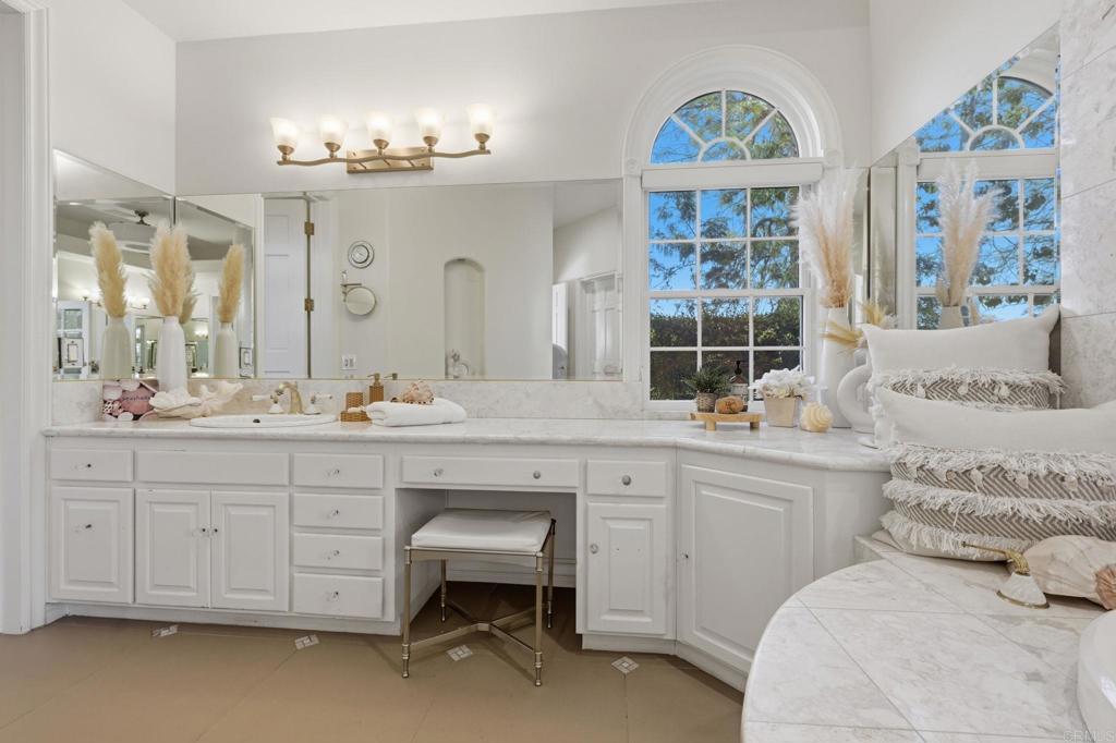 4248 Citrus Drive Fallbrook, CA 92028 - Photo 29 of 71 a spacious en suite bathroom with a double vanity sink a two mirror a window a bathtub and shower