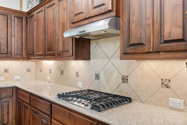 a kitchen with a stove and cabinets