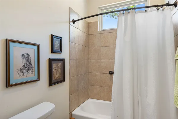 a bathroom with a shower curtain and a toilet