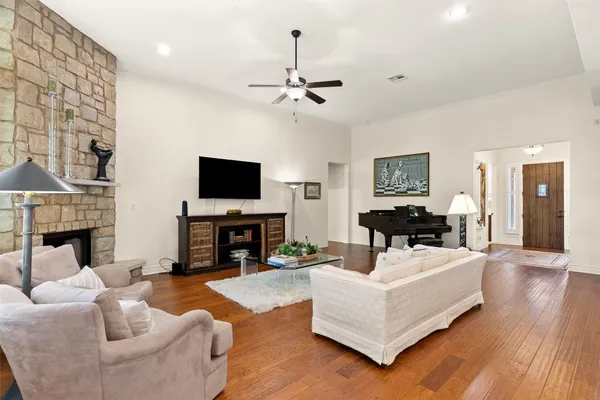 a living room with fireplace furniture and a flat screen tv
