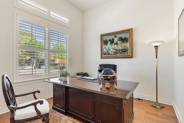 a view of a workspace with furniture and a window