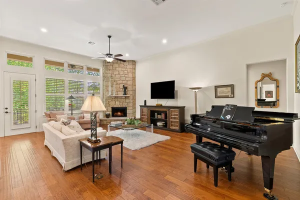a living room with furniture a fireplace and a flat screen tv