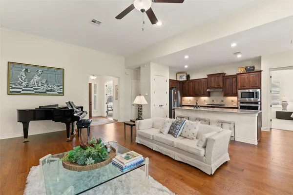 a living room with furniture and kitchen view