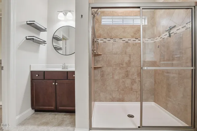 a bathroom with a shower a mirror and a shower