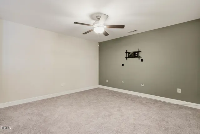 a view of an empty room with a fan
