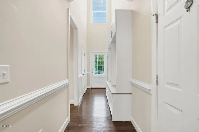 a view of a hallway with wooden floor