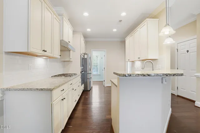 a kitchen with stainless steel appliances granite countertop a sink and cabinets