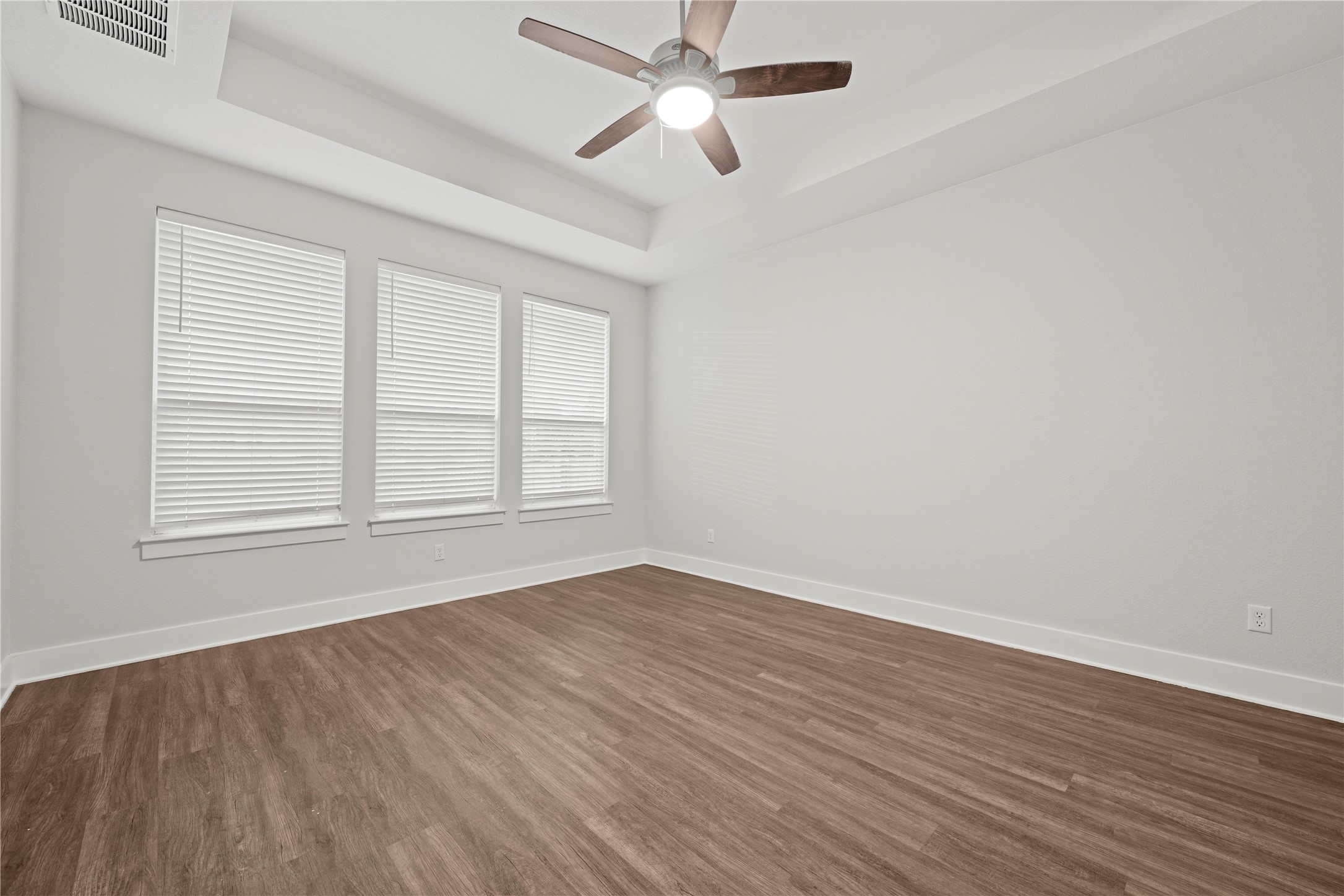 60 Rancho Trail Georgetown, TX 78628 - Photo 14 of 36 Rich wood-inspired flooring and an elegant tray ceiling define this versatile room.