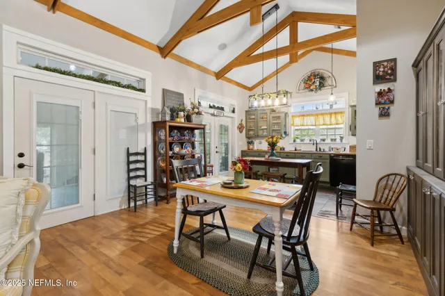 a dining room with a wooden table and chairs