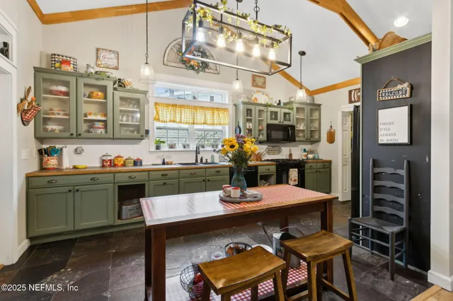 a view of a dining room with furniture and chandelier