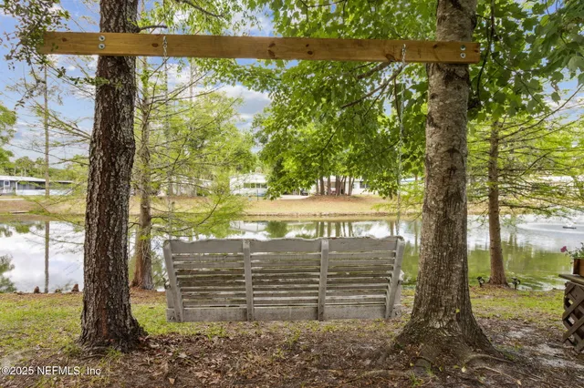 a living room with furniture a flat screen tv and a large window