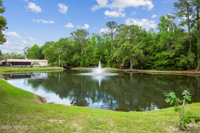 a living room with furniture and a book shelf