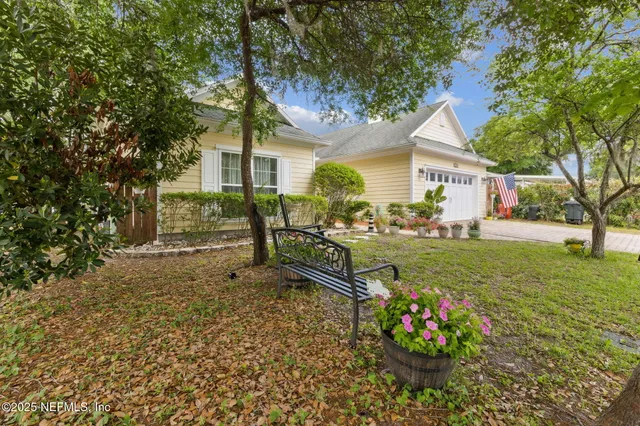a view of a lake with lawn chairs and a table