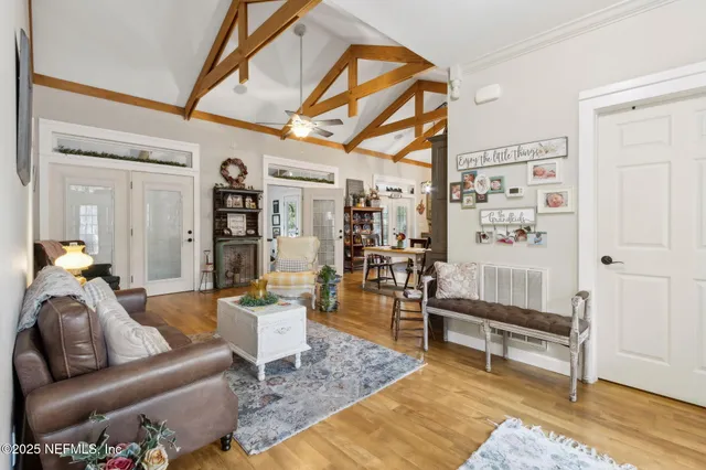 a living room with furniture and wooden floor