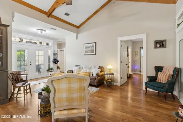 a living room with furniture and wooden floor