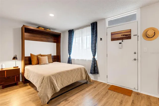 a bedroom with a bed and a window