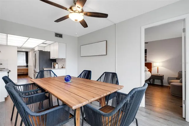 a dining room with a wooden table and chairs