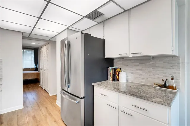 a kitchen with stainless steel appliances granite countertop a sink a stove and wooden floors