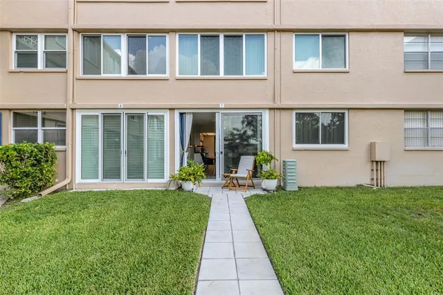 a front view of a house with a yard and trees