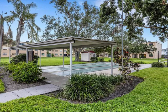 a car parked in front of a brick house next to a yard
