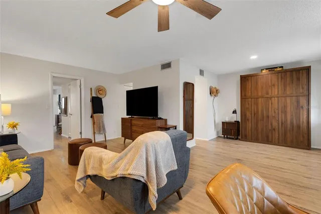 a bedroom with furniture and a flat screen tv