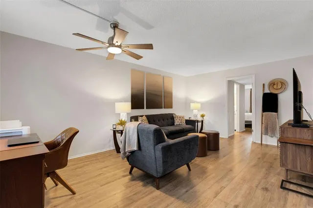 a living room with furniture and wooden floor