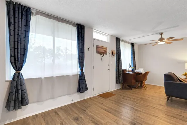 a view of a workspace with furniture and a window