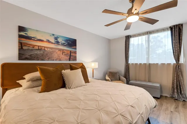 a large bed sitting in a bedroom next to a window