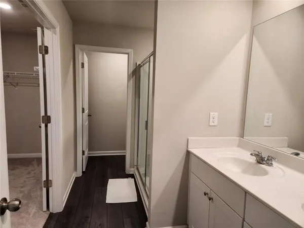 a bathroom with a sink a toilet a shower and a mirror