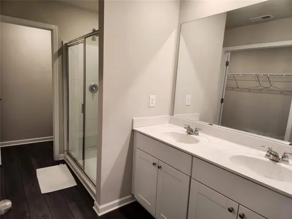 a bathroom with a double vanity sink and mirror
